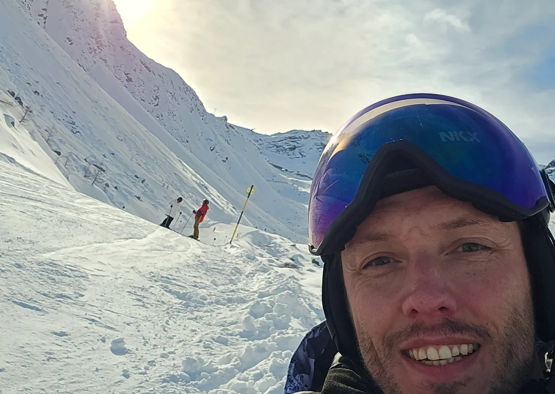 Chris snowboarding in the mountains