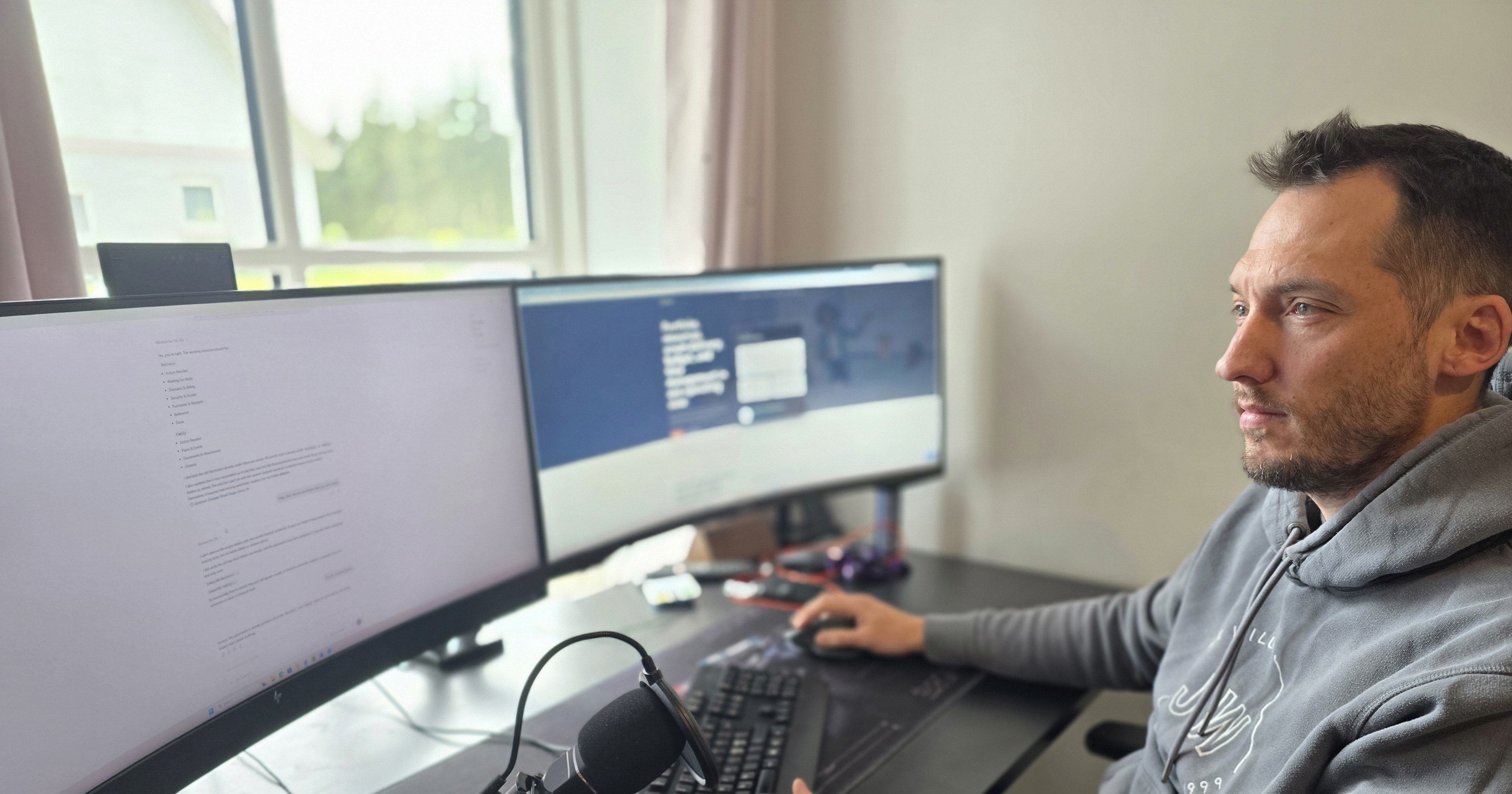 Chris working at a dual-screen workstation